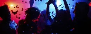 Crowd dancing under colorful lights
