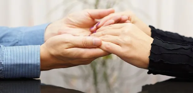 Two people holding hands