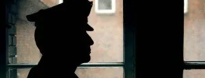 Silhouette of a person beside a window