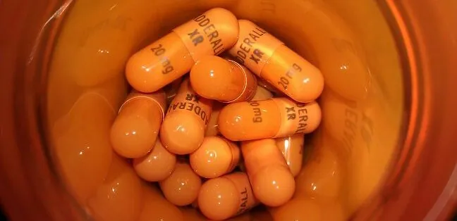 Orange tablets inside a prescription bottle