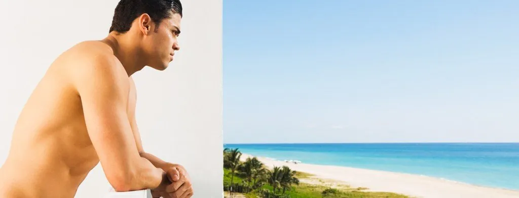 Man sitting beside the sea