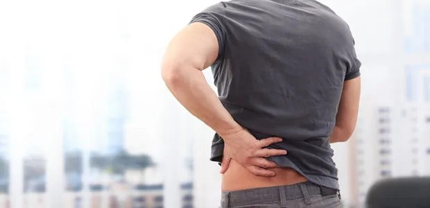 Person holding their lower back